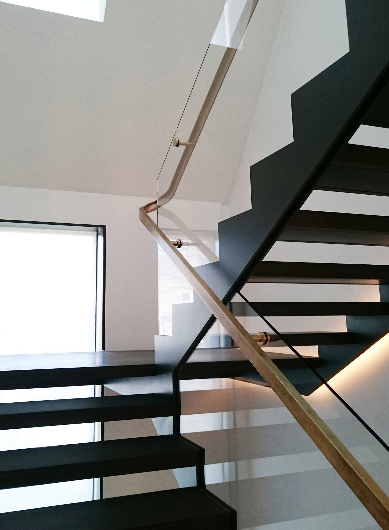 a staircase with brass handrail